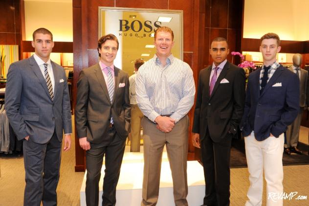 Baltimore Ravens Center Matt Birk is flanked by Hugo Boss models sporting the latest spring styles.